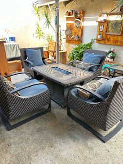 Propane gas fire pit table with crystal rocks and rectangular chairs