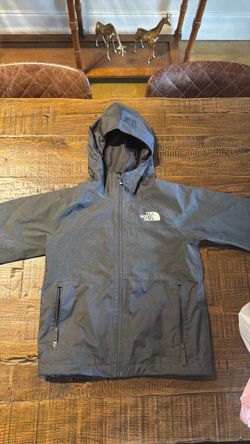 Kids ski gear: north face jacket, boots and Trespass bibs