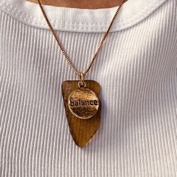 Sandalwood-colored sea glass placed on an 18K gold plated necklace