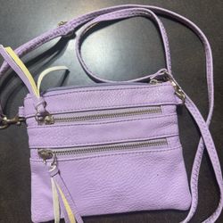 Crossbody adjustable strap with a few zippered pockets, lilac color