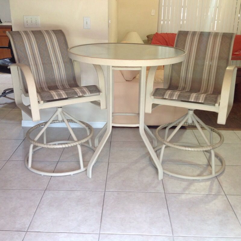 Patio high top table and two swivel top chairs