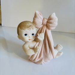 Ceramic Infant Baby Carried  In Pink blanket with Big Bow. Preowned. Comes from a smoke free environment. 
