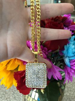 New 14 k yellow gold Cuban link chain and pendant
