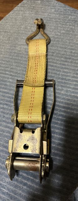 This is a ratchet tie-down strap with J-hooks, used for securing cargo on trailers or trucks.
