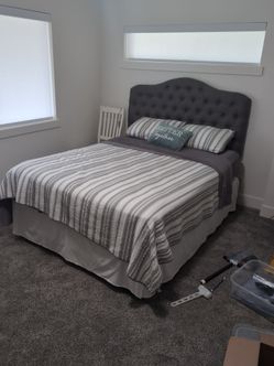 Queen sized tufted headboard and bed frame.