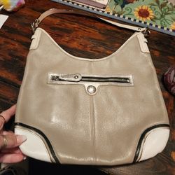 Nice ladies leather purse...lots of room...in good condition ...color is tan with off white accent and black trim...a little discoloration on the trim