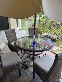Glass table with chairs and umbrella