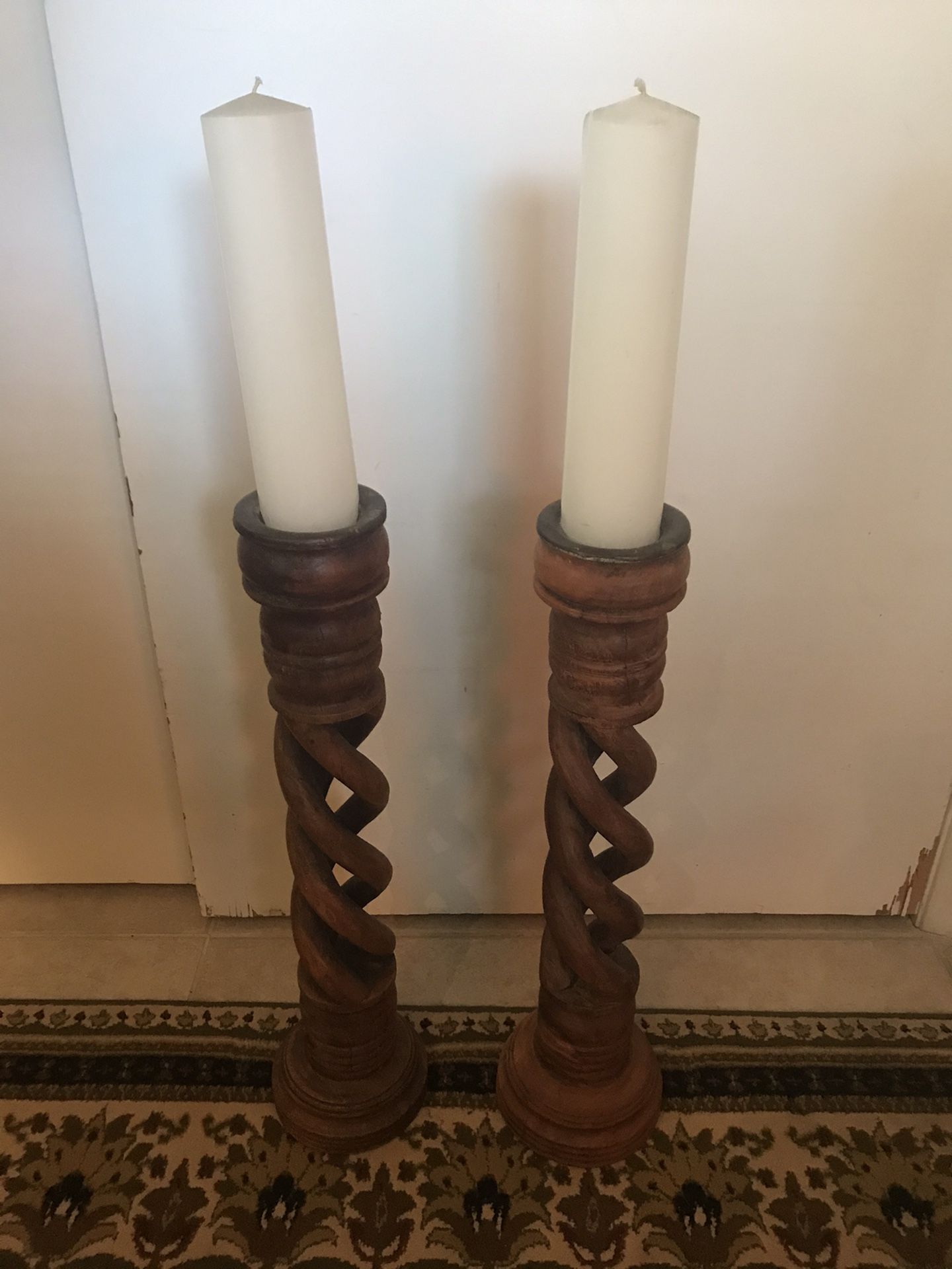 PAIR of large (26”H) pillar candle holders- hand carved, spiral- olive wood? Candles included.