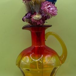 exquisite amberina red, orange, and yellow crackle glass pitcher is a testament to the timeless beauty of mid-century modern design. 