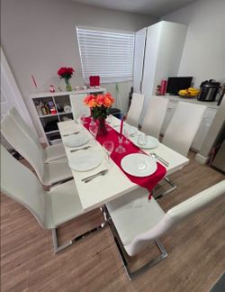Dining set with 8 leather chairs—lightly used.