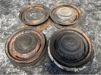 Four matching 15x5 Chevy car wheels with caps. 5 on 4.75 lug 49-53