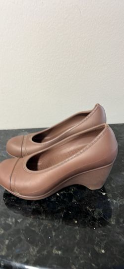  a pair of Crocs Lina wedge pumps in brown. 