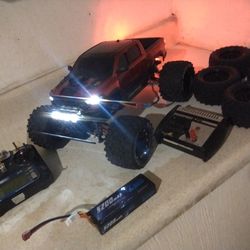 traxxas stampede 4x4 brushed, 2 lipo batteries charger, and 2 set of wheels