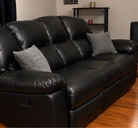 Black recliner and black couch in Bronx