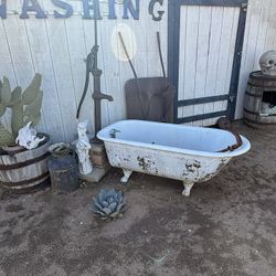 Vintage Cast-Iron Bathtub And Water Pump
