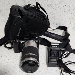 Sony A5000 Body Camera And Sony 4.5-6.3/55-210 Lens, 3 Batteries, Charger, Cable, Strap And A Bag