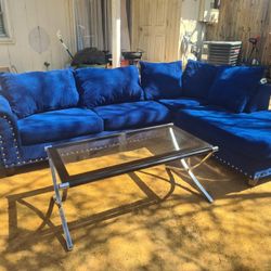 Blue L Shaped Couch With Table And Lamp