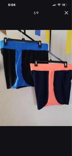 TWO WOMENS TEK GEAR WIND SHORTS. SIZE MEDIUM.