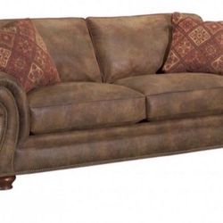 Large brown cushioned sofa couch with pillows