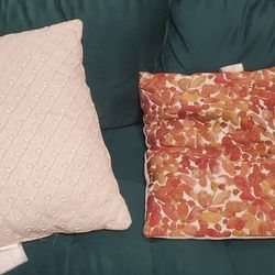 Two Throw Pillows (One Cream Color, One Red/Orange)