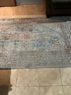 Dark brown five seat couch with area rug