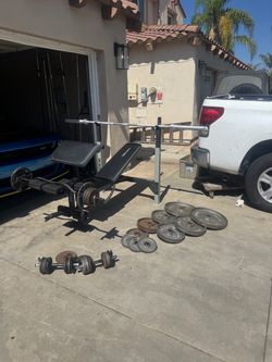 Bench press with 7ft bar and 235lbs of Olympic weights plus 110lbs of standard weights with curl bar