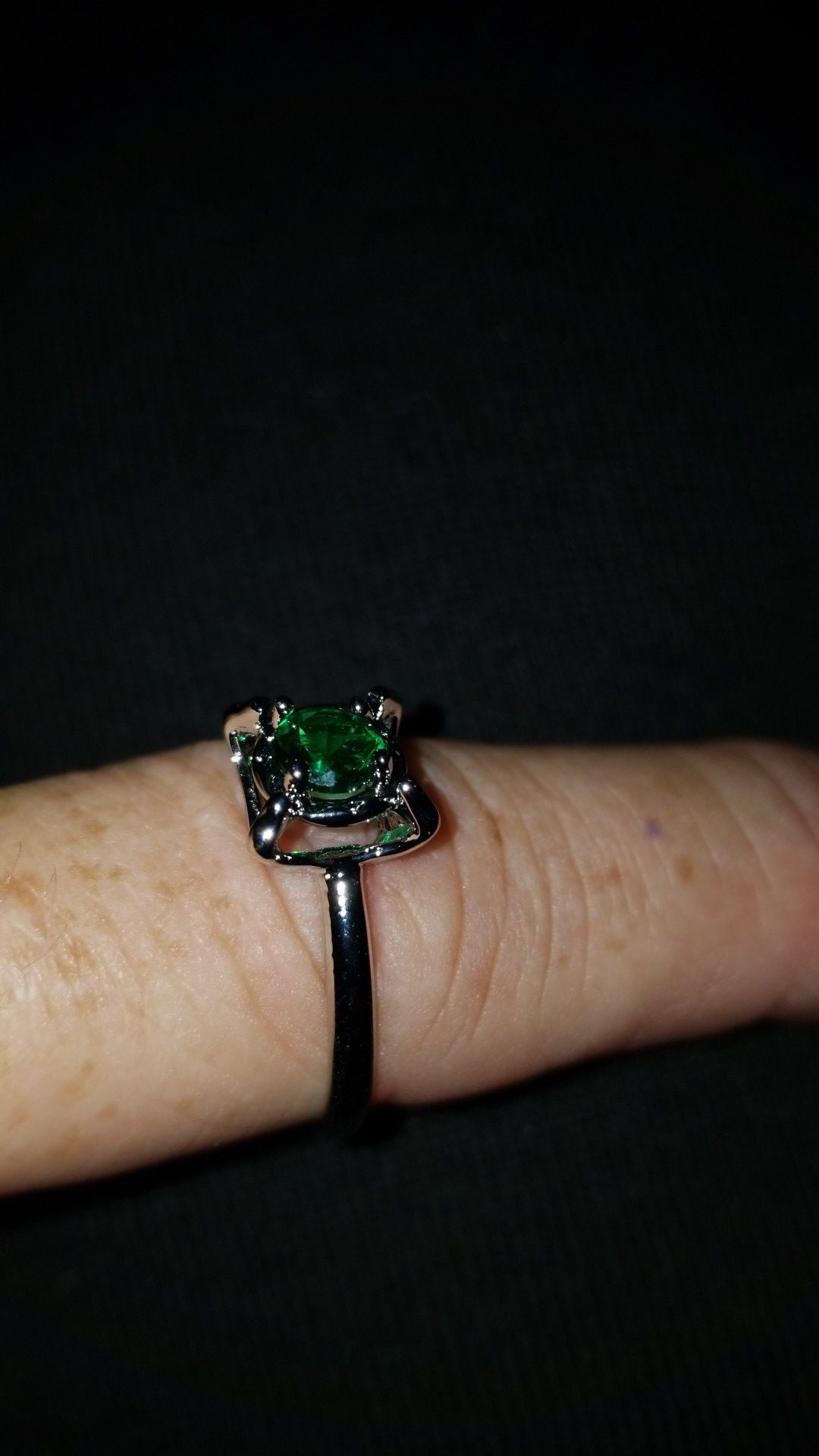 A size 9 rhodium plated Emerald stone ring