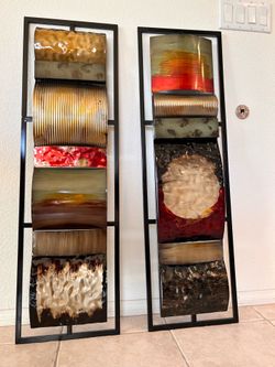 Set of two large piece decorative metal wall art panels.