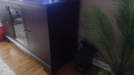 Dark Wood TV Stand with a glass Door .