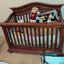 Toddler with baby bed with mattress
