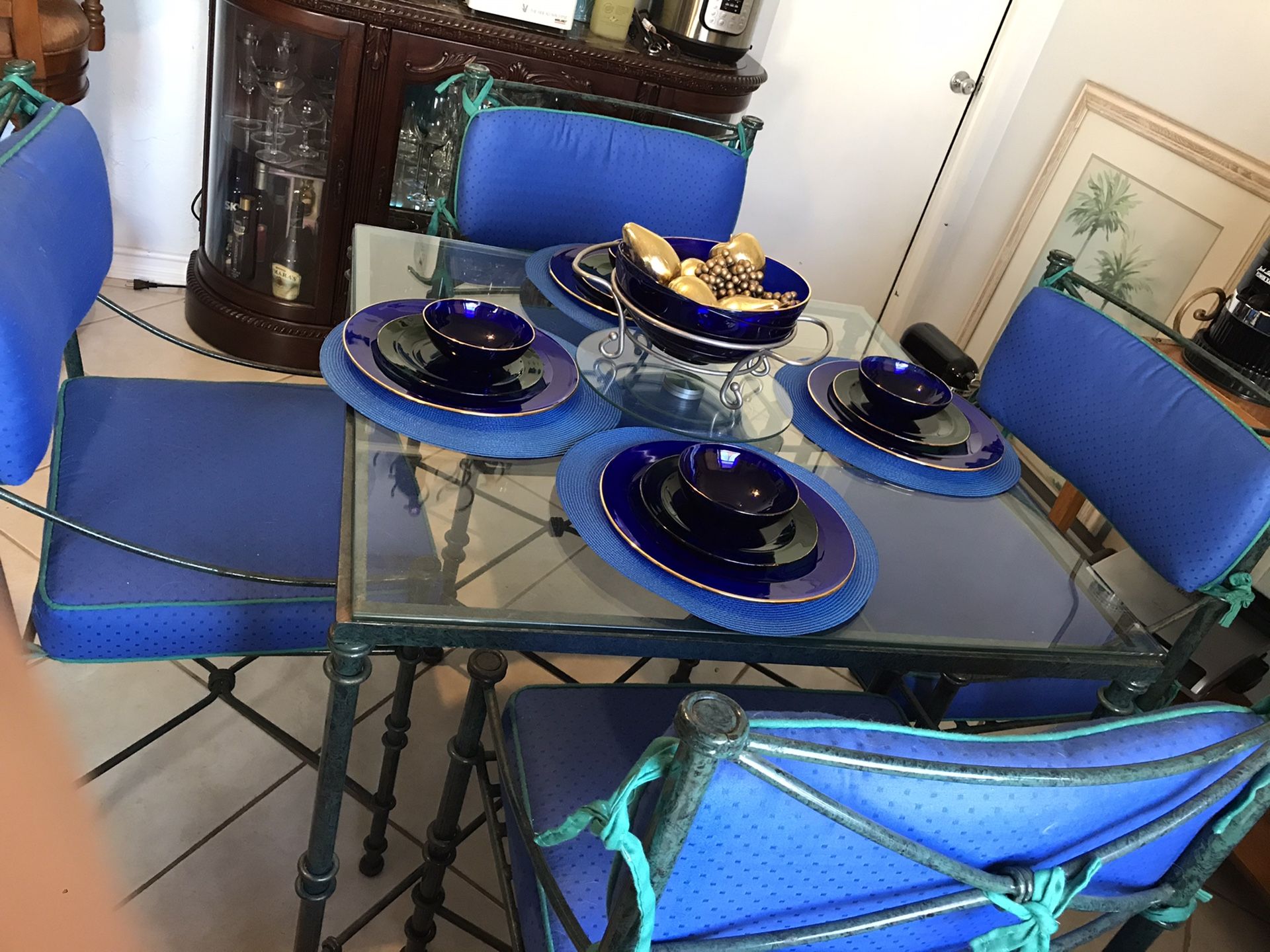 Dining Table and 4 chairs wrought iron/glass top and upholstered custom cushions