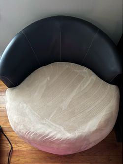 Ashley’s Furniture Oversized Black and beige Faux leather Swivel Accent Chair