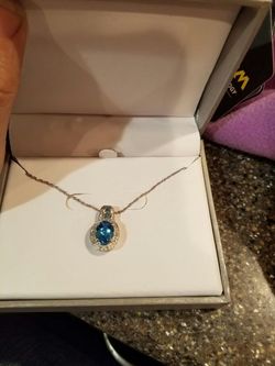 This is a beautiful blue topaz and white diamond charm on a sterling silver chain it is brand new