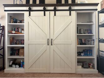 Farm House Entertainment Center (Used) With sliding barn doors in white.