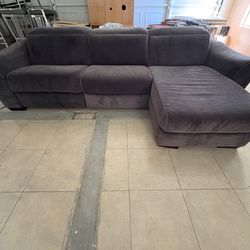 Gray L shaped couch with 1 seat recline