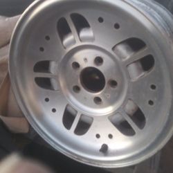 A set of rims and a bunch of tires