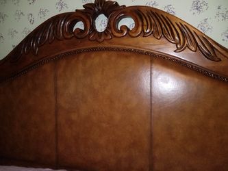 Pulaski wood and leather sleigh bed and vanity mirror.