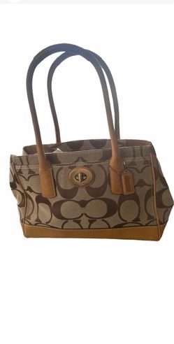 This bag is a vintage Coach Hampton Madeline Signature Satchel, recognizable by its beige-and-brown C-monogram canvas, tan leather trim, and central t