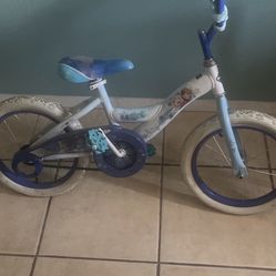 Girls toddler pedal bike. “frozen  characters” The bike is in great condition it just needs new tubes for the front and back tires.  The bike works pe