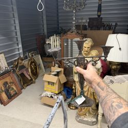 Ornate silver-plated candelabras with relief carvings and three candle holders.