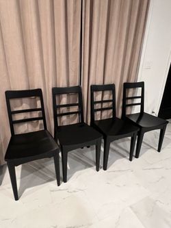 4 Black wooden dining chairs