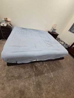 King ghostbed with new sheet set and 2 covers