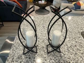 2 black iron wall scones with pillar candles