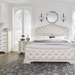 4pc Queen Upholstered Bed with Mirrored Dresser and Nightstand set by Ashley
