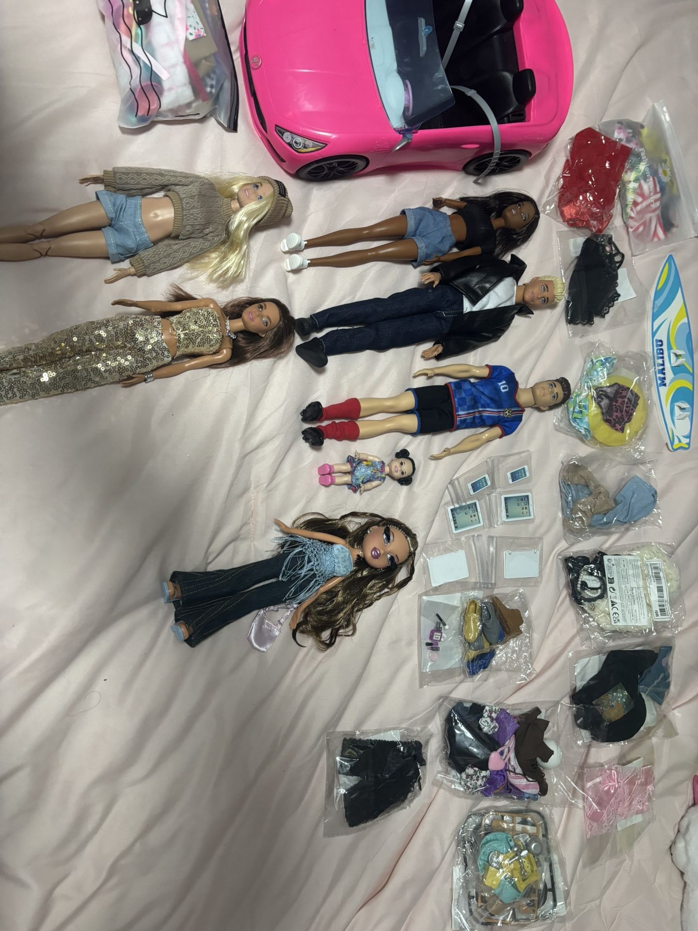 Barbie dolls, car, clothes, and accessories