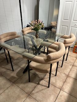 Glass dining table four carpet chairs
