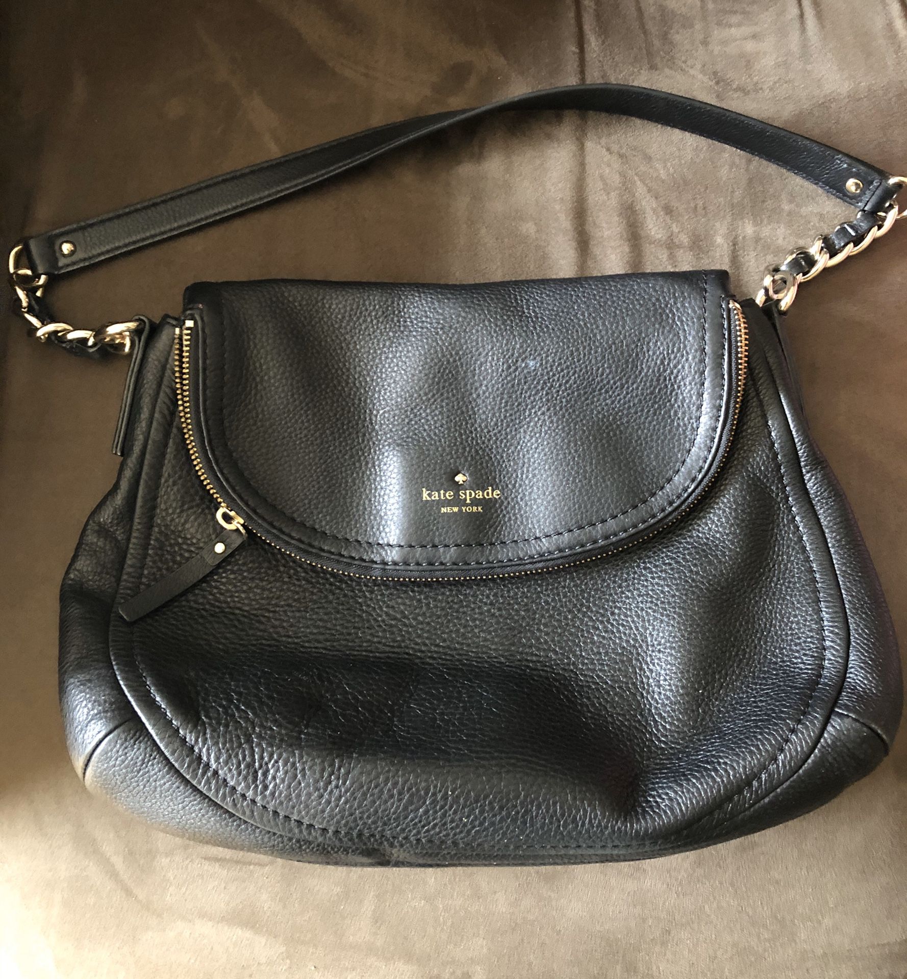 Black leather Kate Spade bag with short strap, striped lining