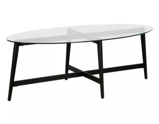 Black oval metal coffee table with glass top
