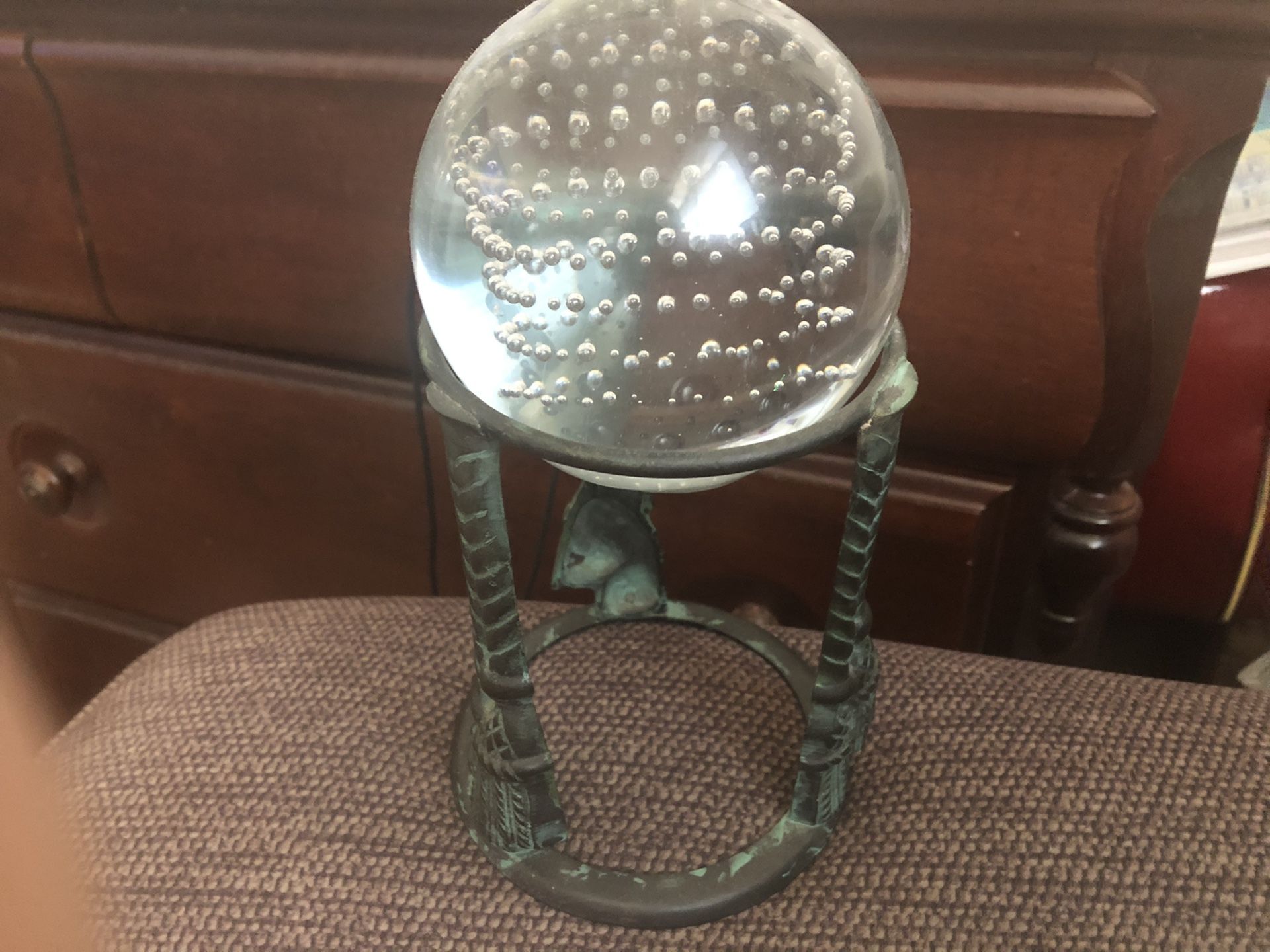 Controlled bubble glass ball 3” on green patina metal stand 6”h