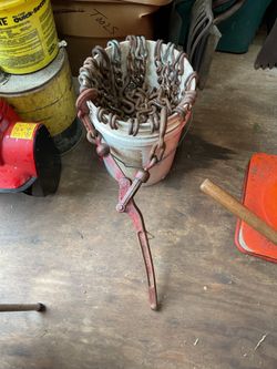 5 gallon bucket full of chains and tool